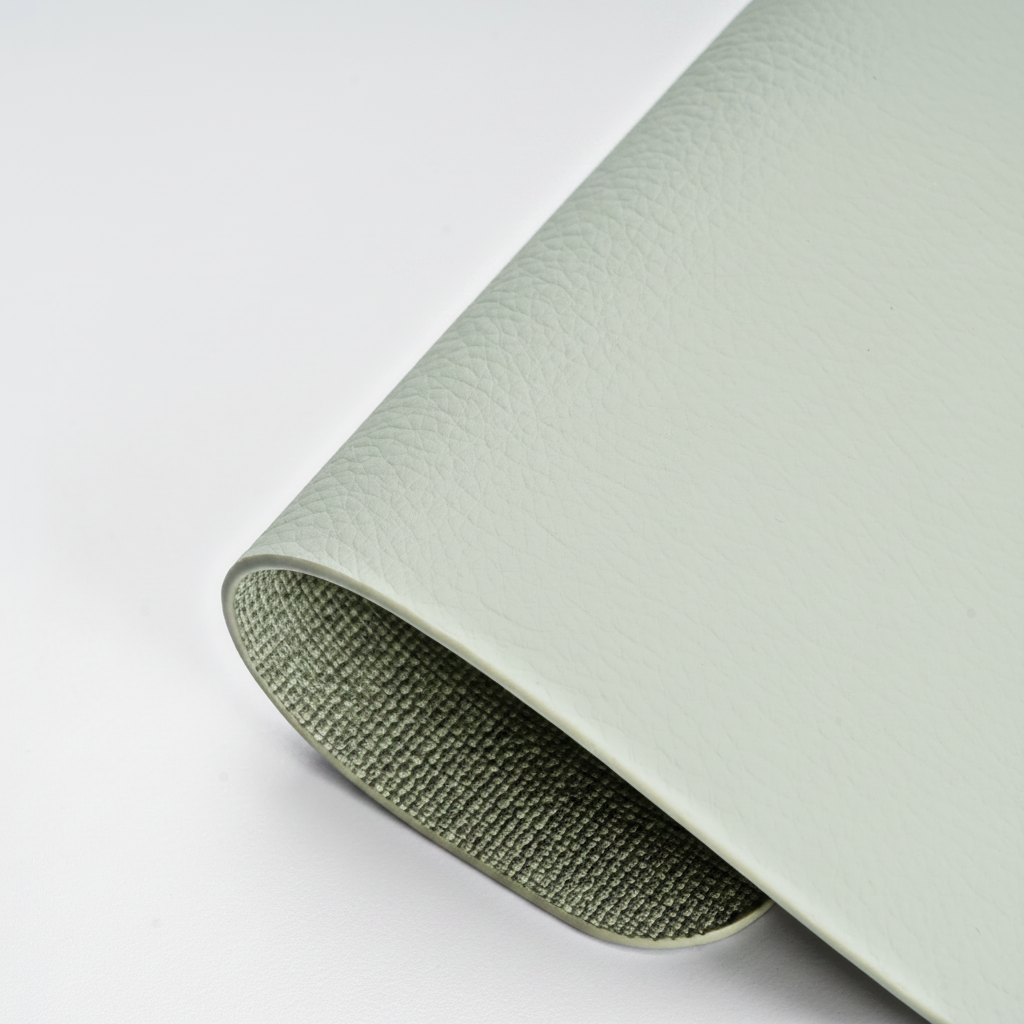 PROMATTOO rectangular faux leather placemat in {color}, 43 × 30 cm, close-up of the linen-look texture